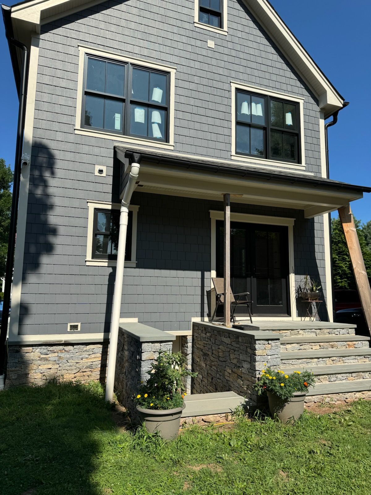 Person using a trowel to smooth wet concrete on a flat surface outdoors.