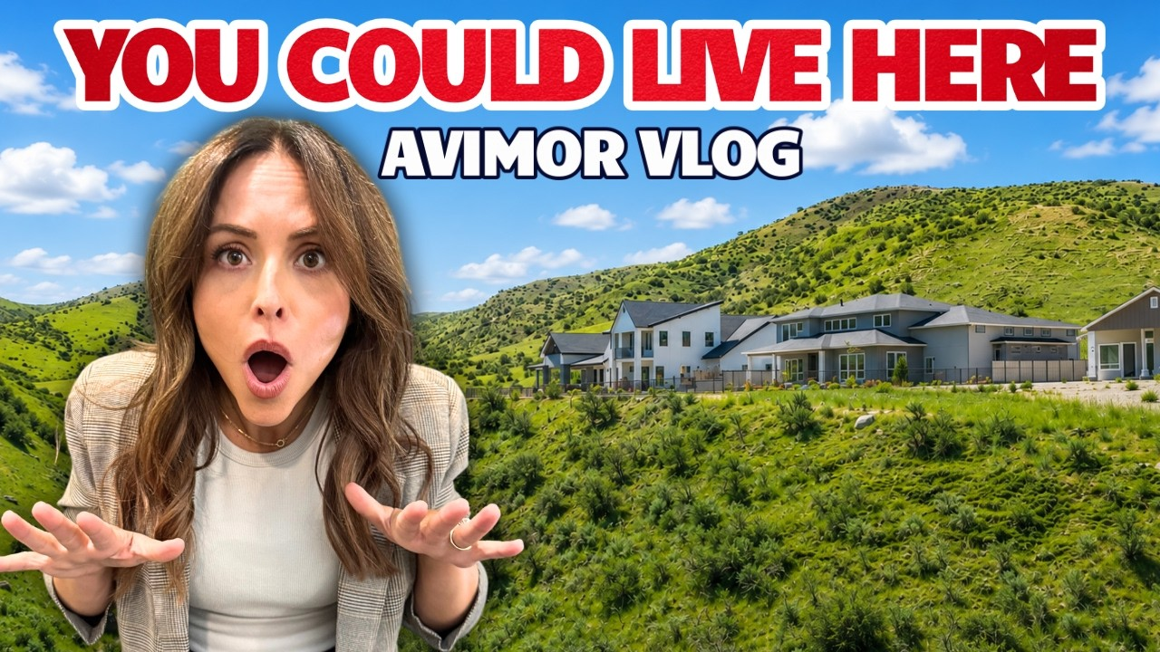 Woman reacting in front of a hillside resort with text “YOU COULD LIVE HERE” and “AVIMOR VLOG”