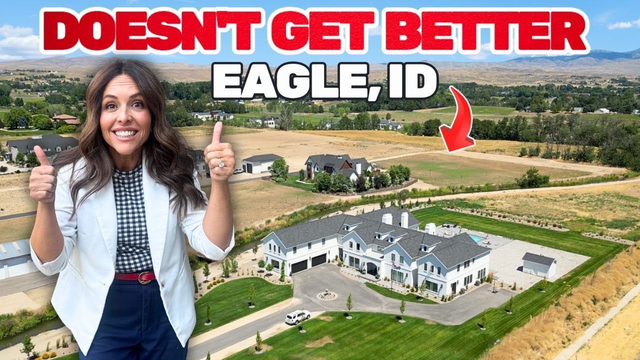 Woman giving thumbs up in Eagle, ID, near large house with a white exterior on a grassy lot with other houses in the background.