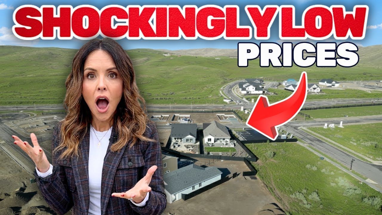 Woman with surprised expression gestures towards homes with a 