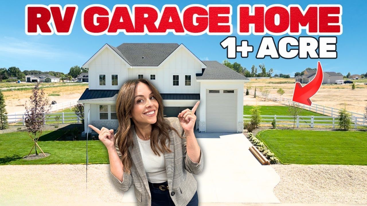 Woman points at a white house with an RV garage on a 1+ acre lot.