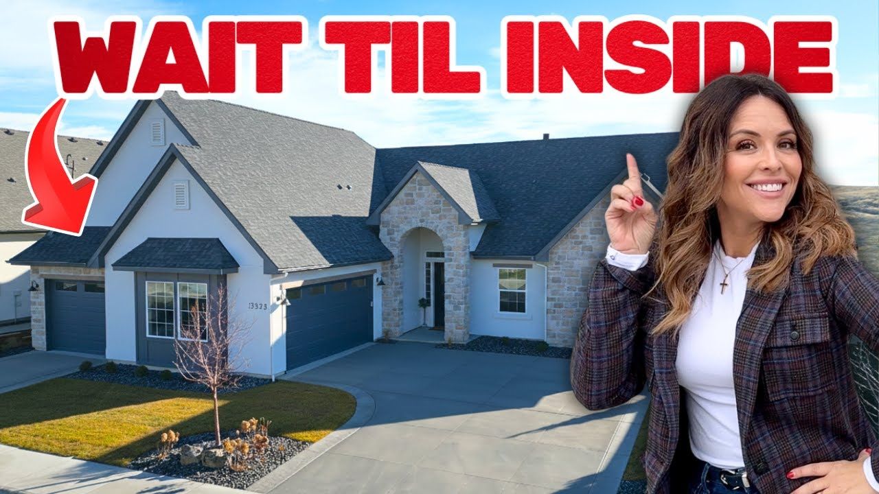 Woman points towards a modern house with stone and gray accents, text