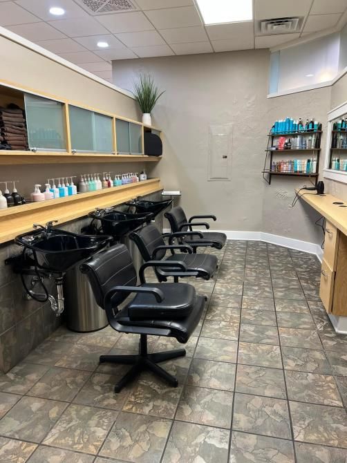 A man is using a vacuum cleaner to clean a carpet in a living room.