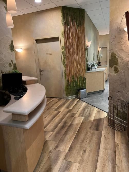 A man is using a steam cleaner to clean a carpet in a living room.