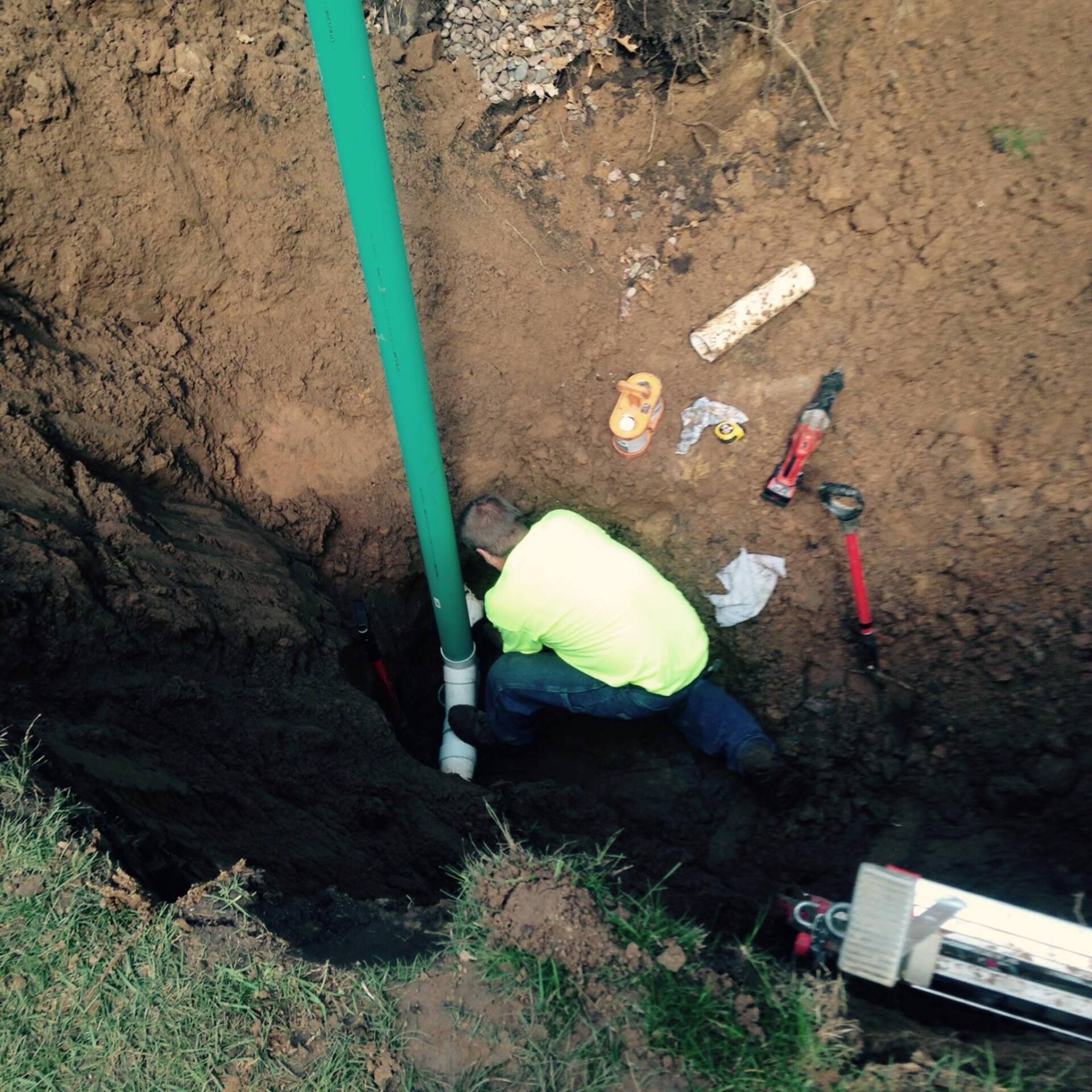 Man Holding Pipe — Black River Falls, WI — Callahan & Son Plumbing & Septic