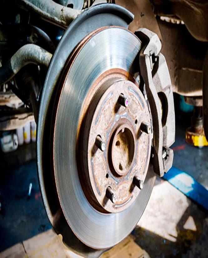 A close up of a brake disc on a car.