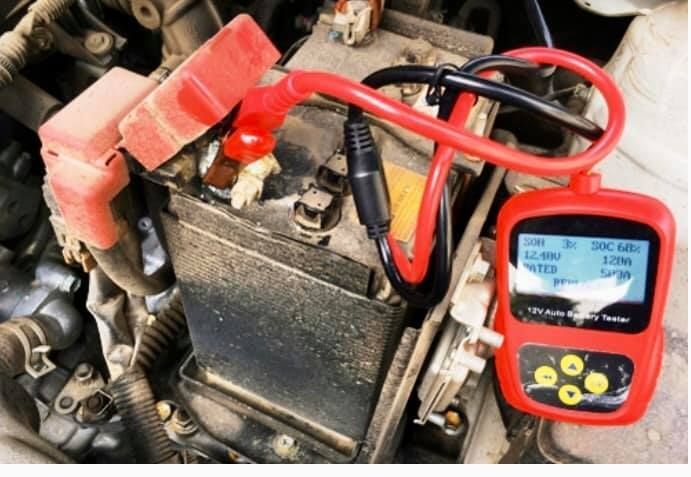 A car battery is being charged by a jump starter.