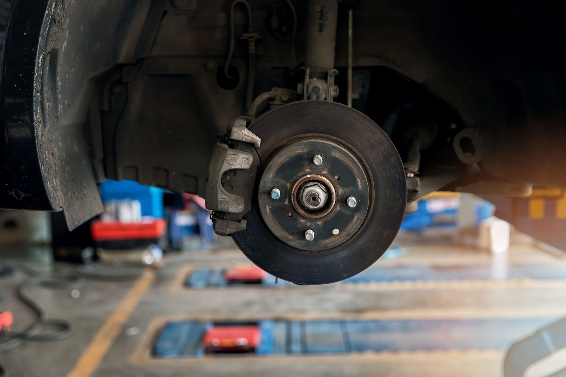 A car wheel is being repaired in a garage.