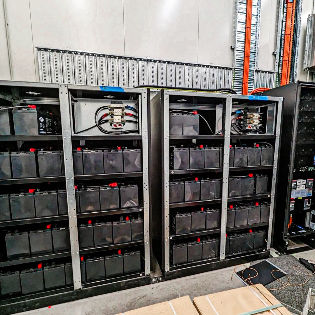 Industrial Batteries Neatly Arranged in Metal Shelves — API Engineering in Charmhaven, NSW