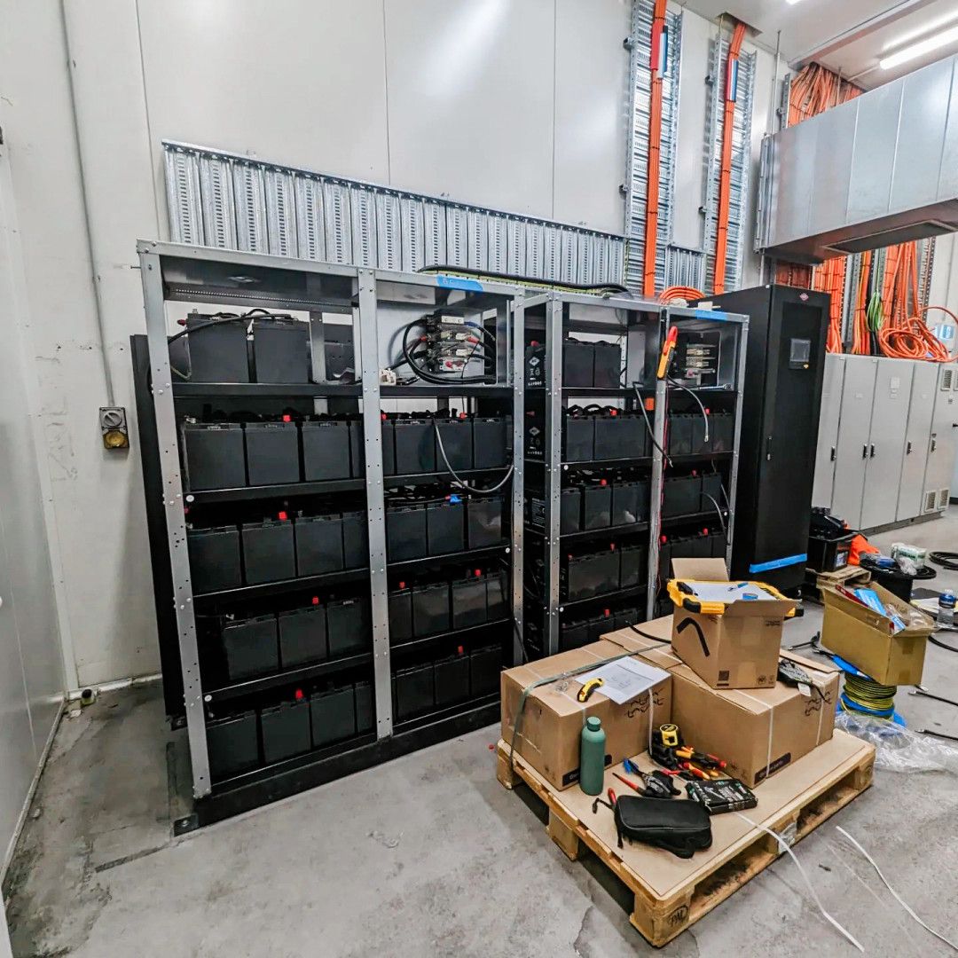 A Room With Large Battery Racks, Cables, and UPS Units — API Engineering in Charmhaven, NSW