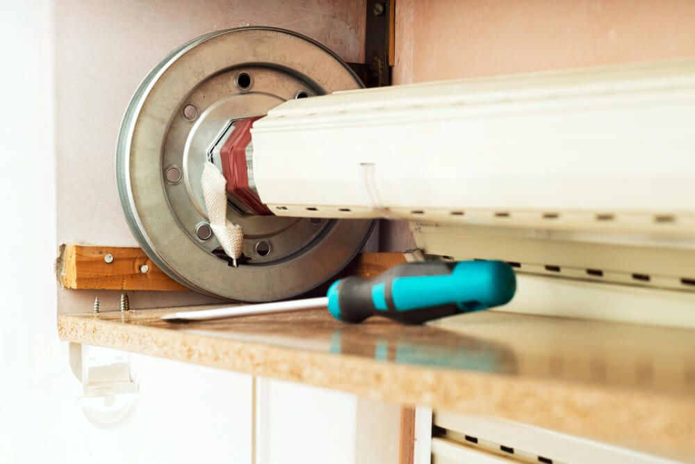 A Screwdriver is Sitting on a Counter Next to a Roller Shutter — Wow Clean Cairns in Bayview Heights, QLD