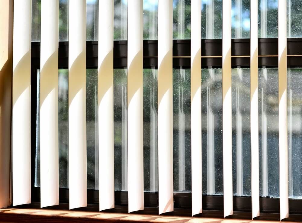 White blinds on the window — Curtain & Blind Cleaners in Bayview Heights, QLD