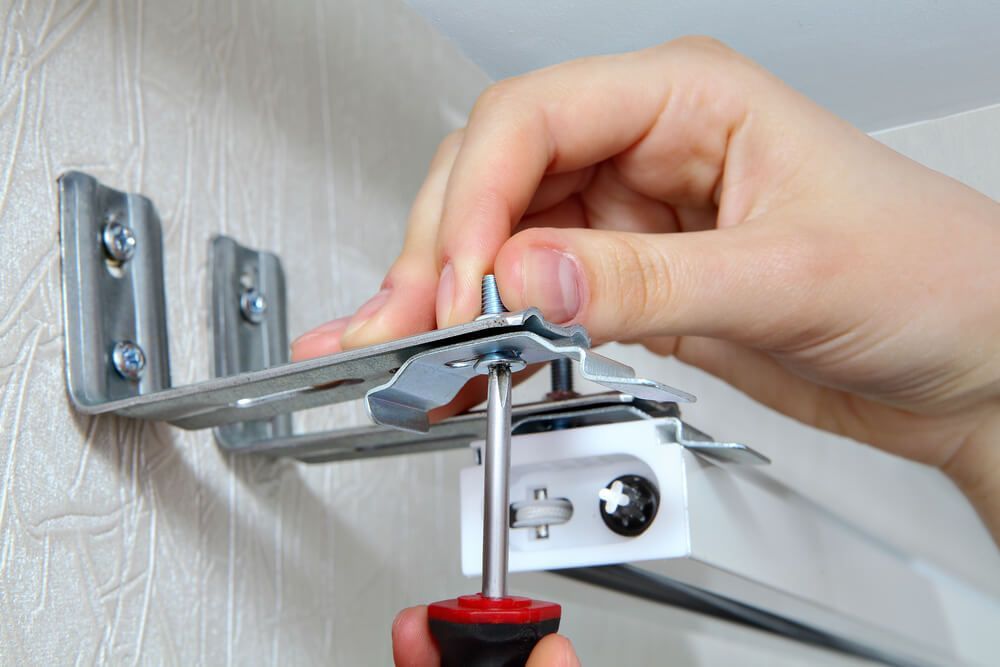 Man Installing Window Blinds Mounting — Wow Clean Cairns in Bayview Heights, QLD