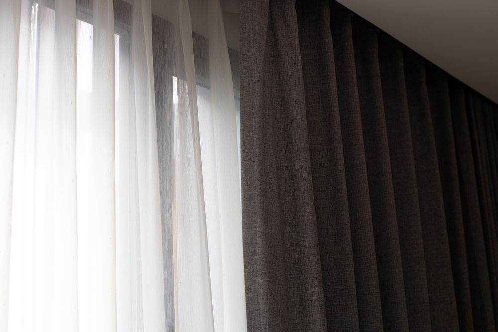 Sheer White Curtains Next to Dark Gray Blackout Curtains, Partially Covering a Window — Wow Clean Cairns in Stratford, QLD
