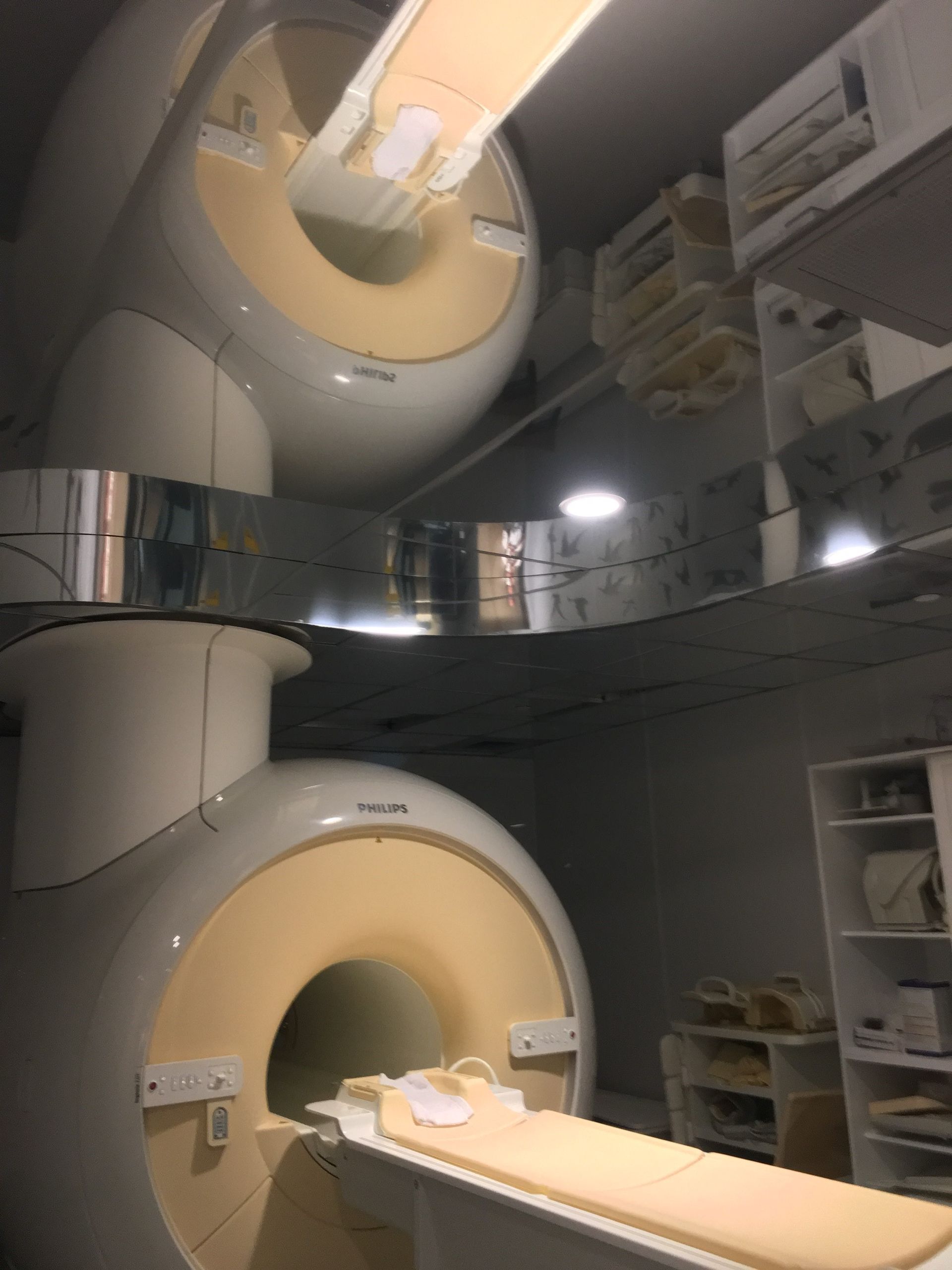 Two mri machines are sitting next to each other in a room