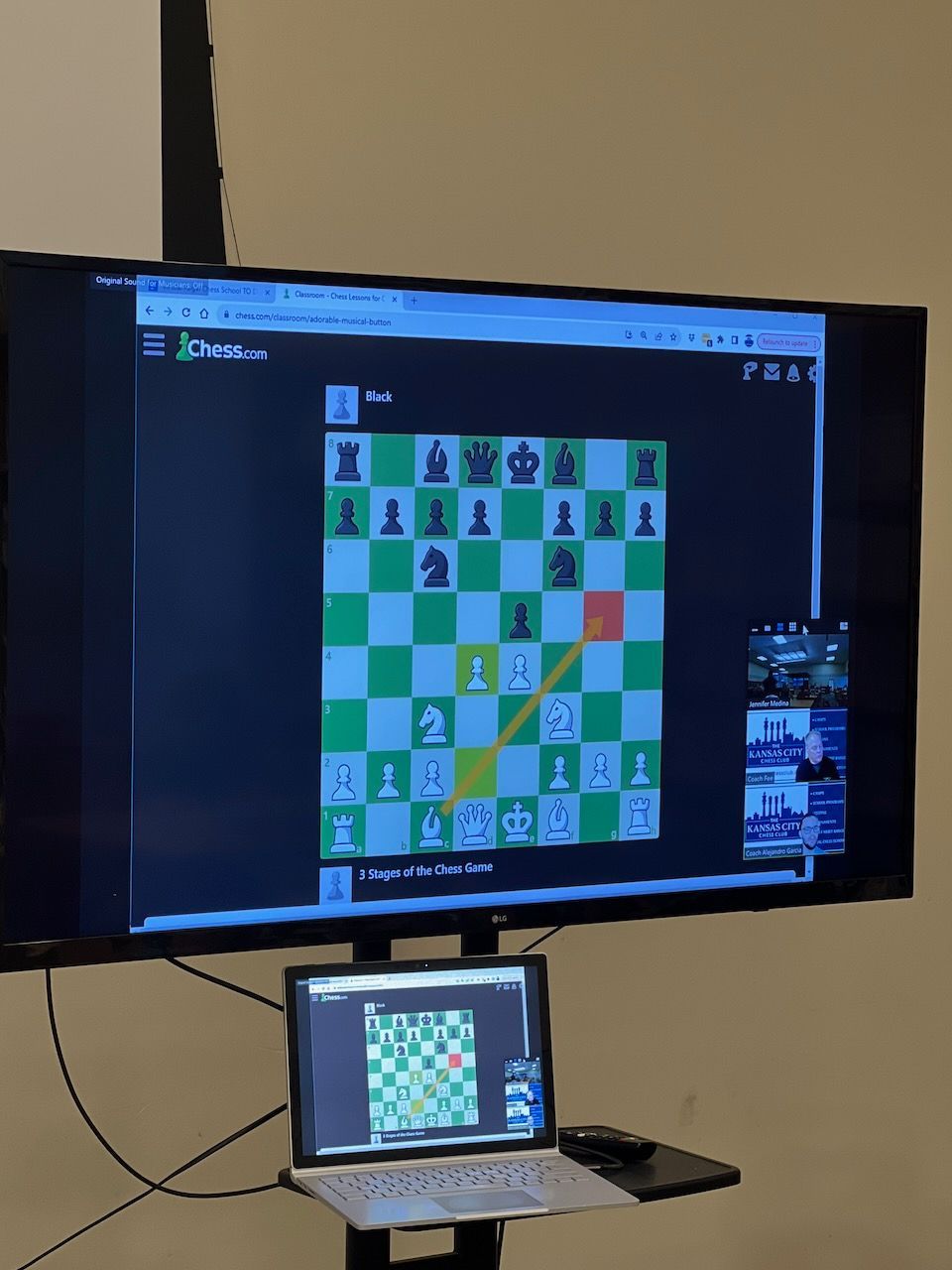 A chess game is being played on a large screen