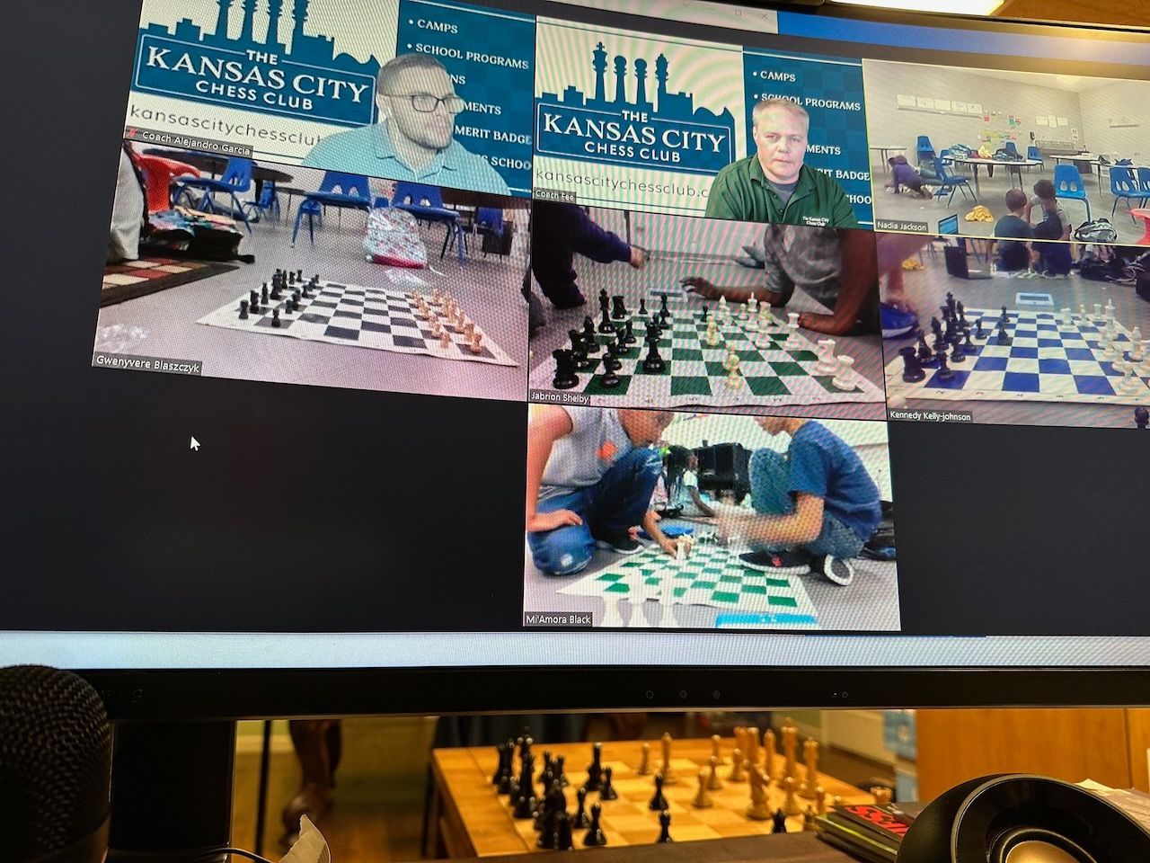 A computer screen shows pictures of people playing chess in kansas city