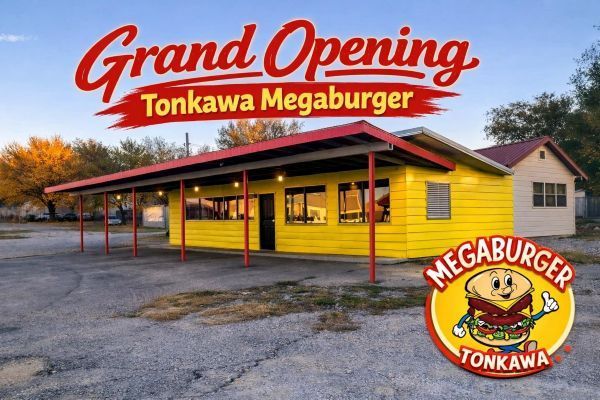 Grand opening of Tonkawa Megaburger: Yellow restaurant with red trim, logo with smiling burger, clear blue sky.