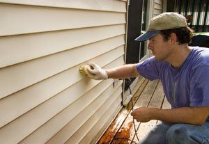 Man Cleaning The Wall — Roofing And Siding in Toledo, OH