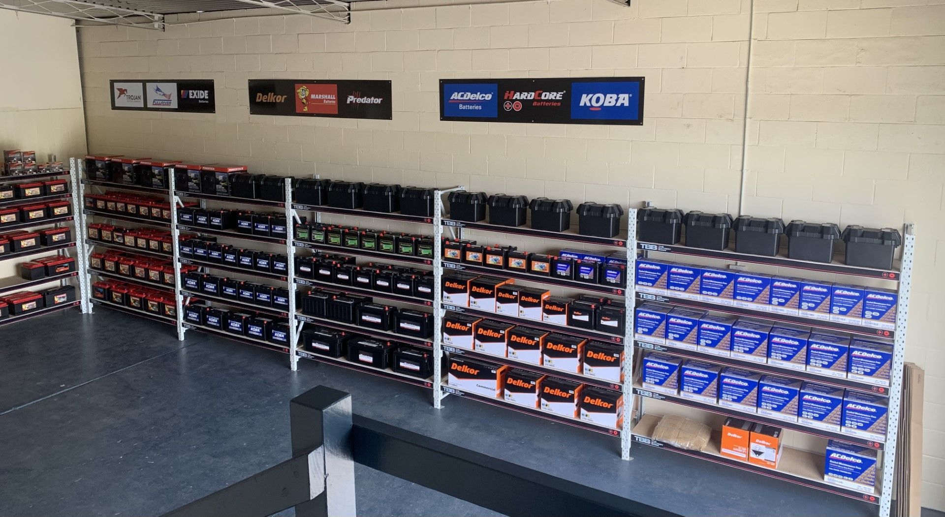Shelves of Automotive Batteries in Various Colors at a Shop — Battery in Grafton, NSW
