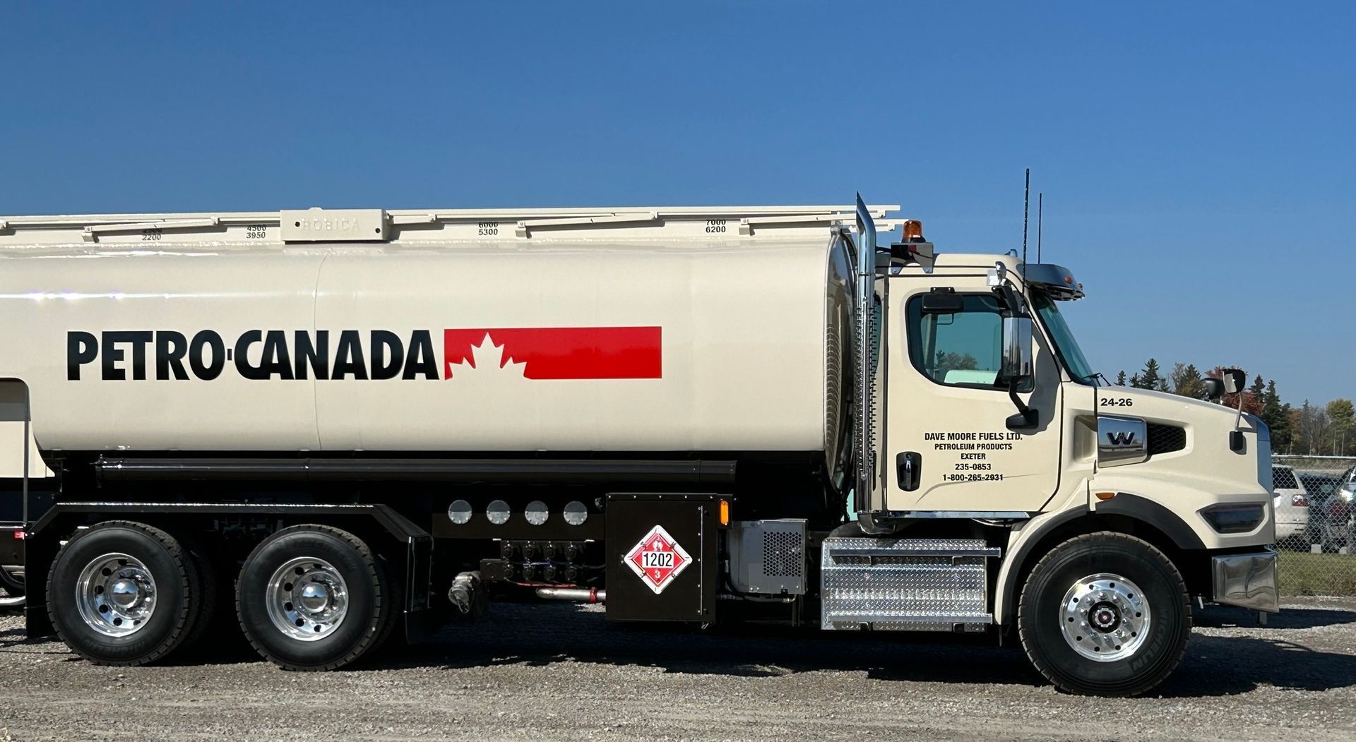 A petro canada truck is parked in a gravel lot