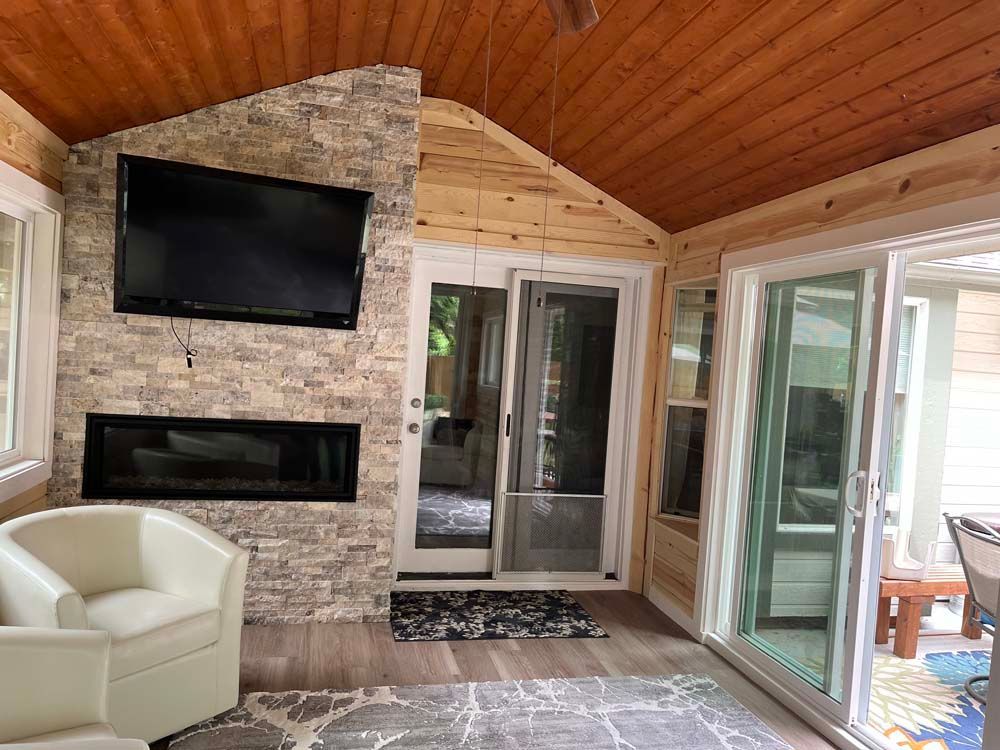 A living room with a fireplace and a flat screen tv.