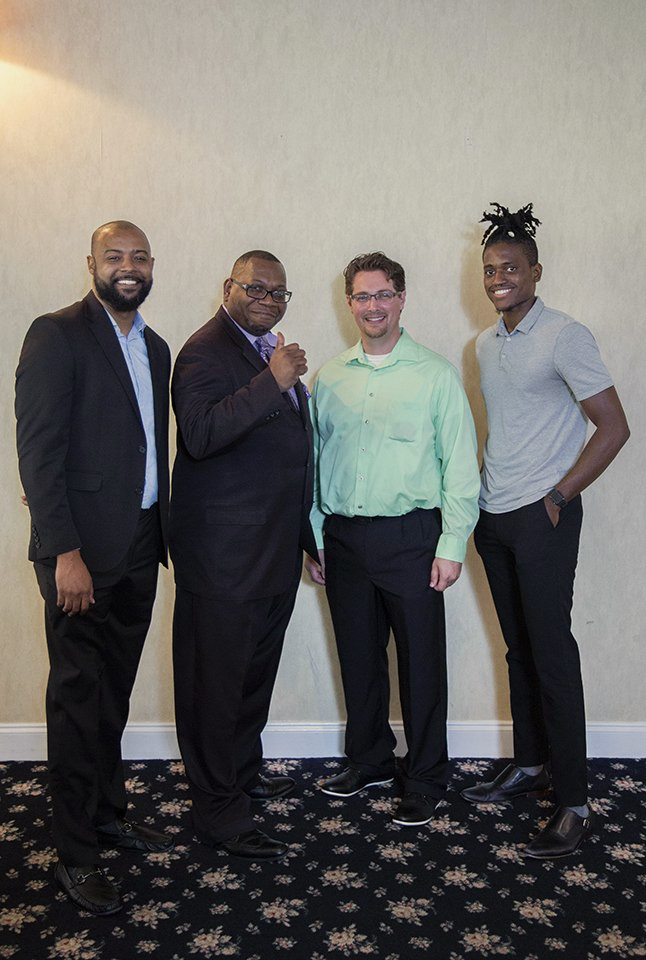 A group of men are posing for a picture together