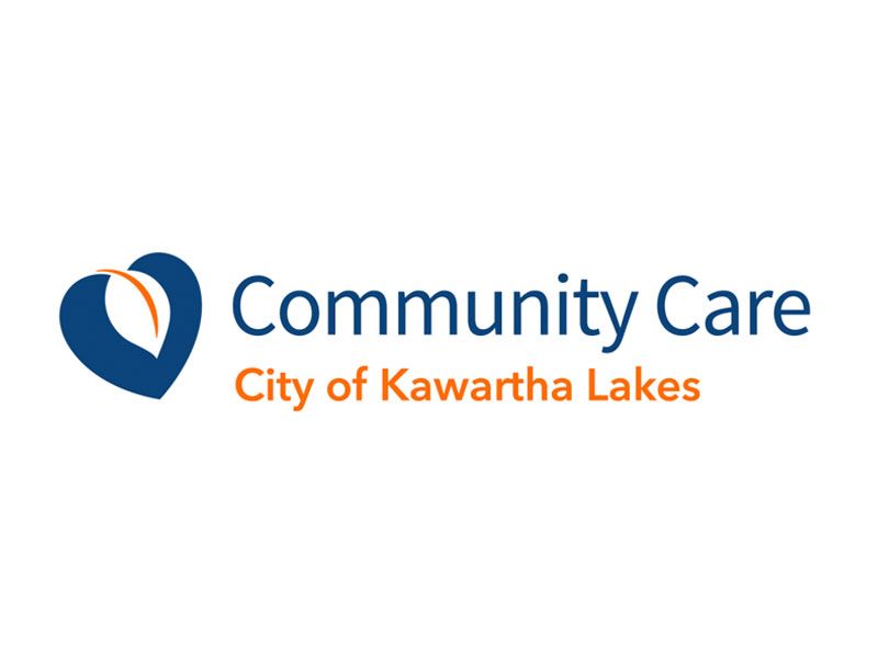 The logo for Community Care City of Kawartha Lakes, featuring a blue heart icon with an orange leaf shape inside.