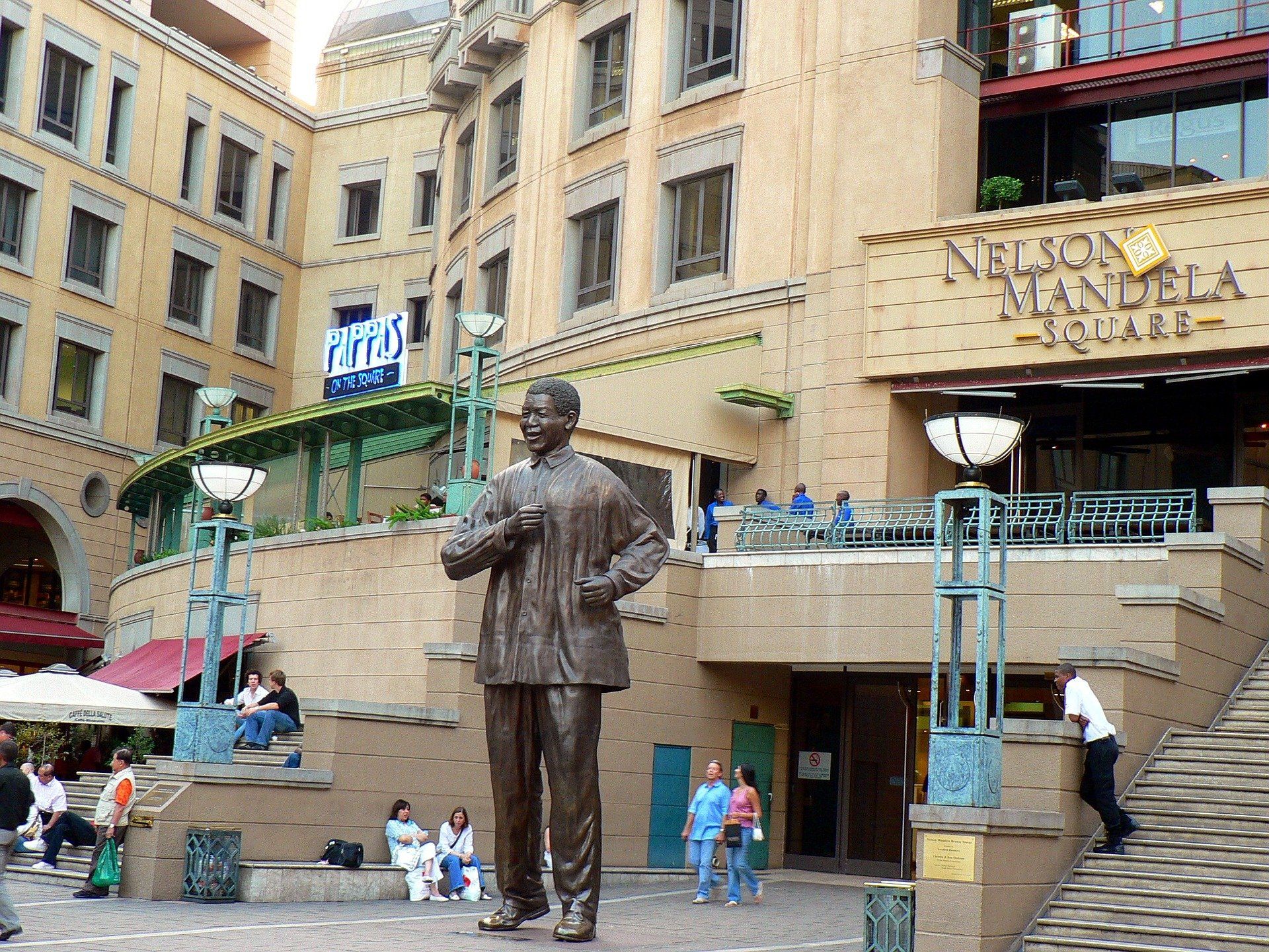 A statue of a man in front of africa mandela square