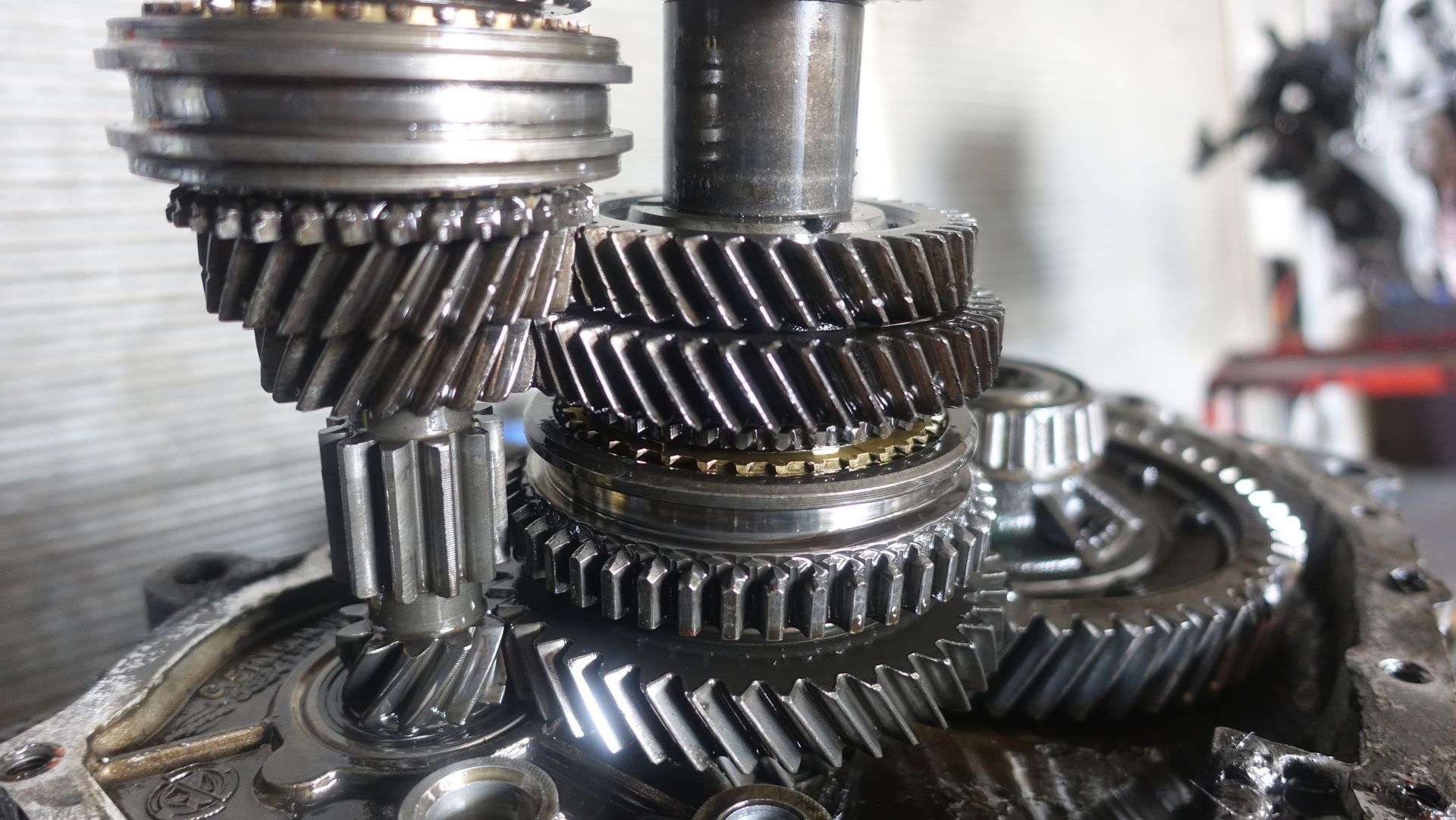 Close-up of stacked metal gears and shafts in a mechanical gearbox assembly