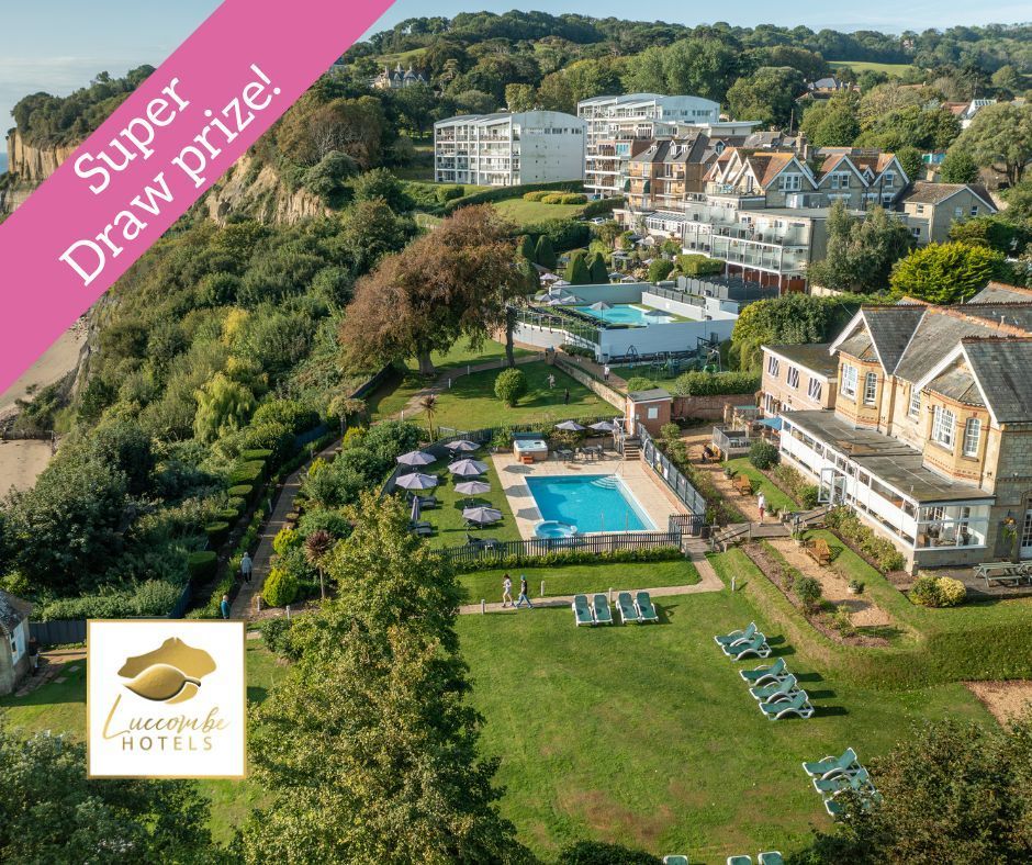 an overhead view of a hotel with pool and lawns. The edge of a beach can be seen on the left hand side of the image.