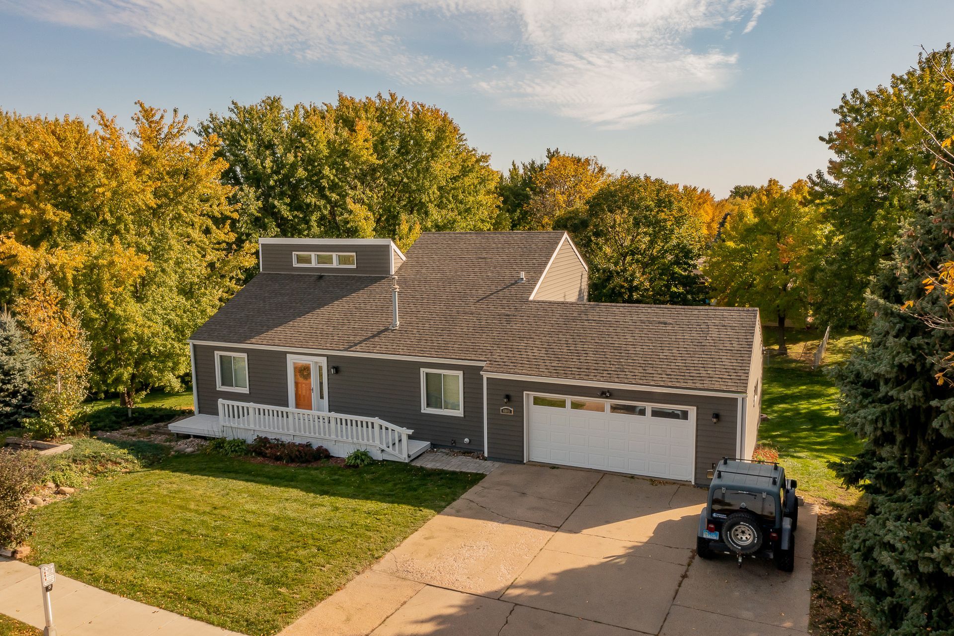 An aerial view of a house with a car parked in front of it.