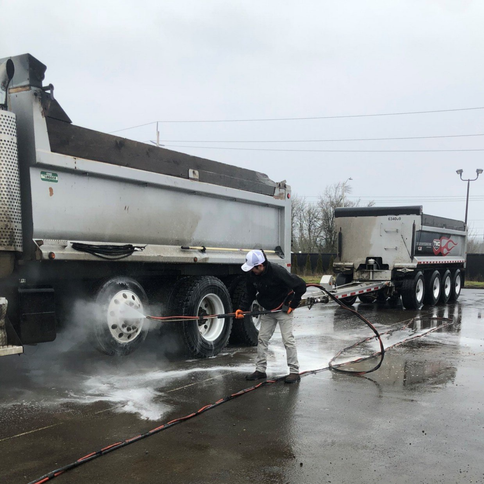 A Man Cleaning A White Patio — Vancouver, WA — 3 Brothers Pressure Washing LLC