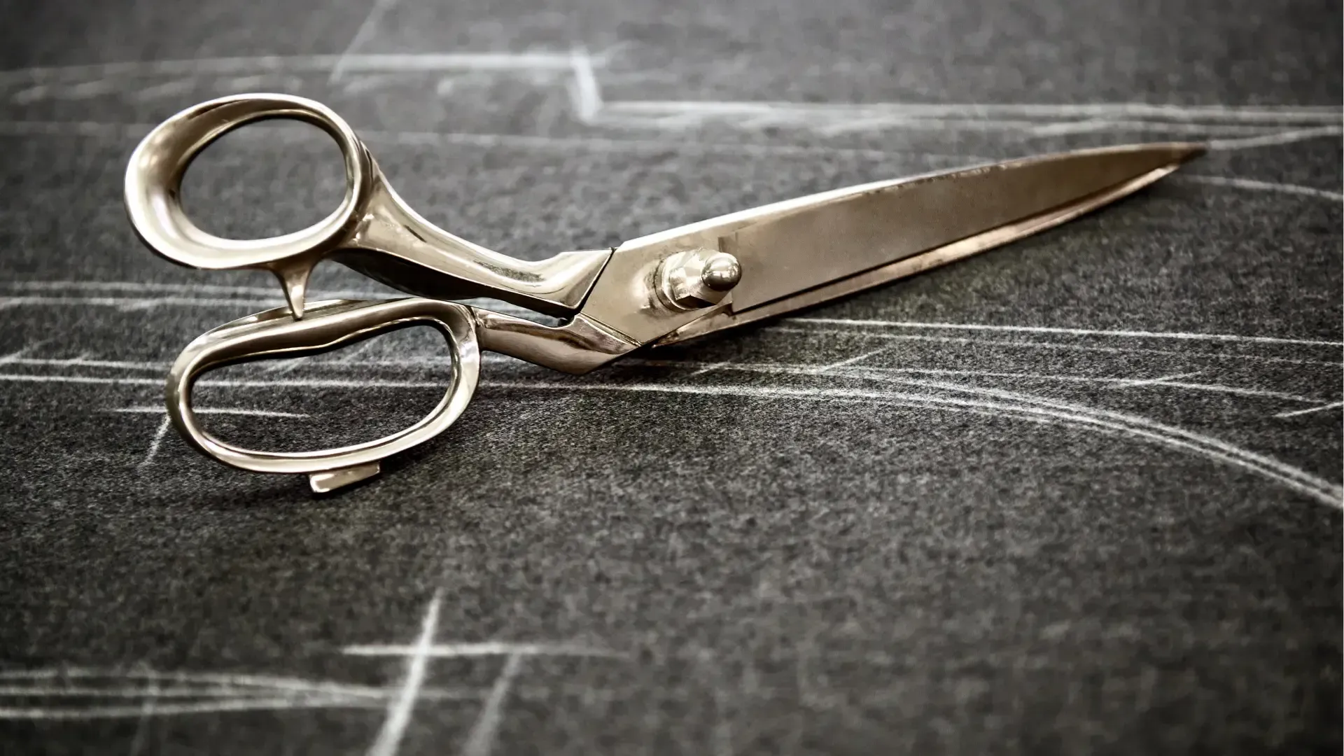 A bride and groom are hugging and the bride is wearing a veil.