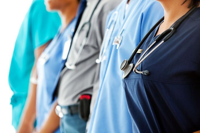 A group of doctors and nurses are standing in a row