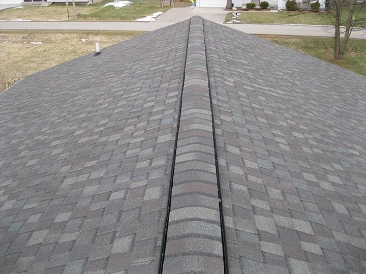 A close up of a roof with a drain on it.