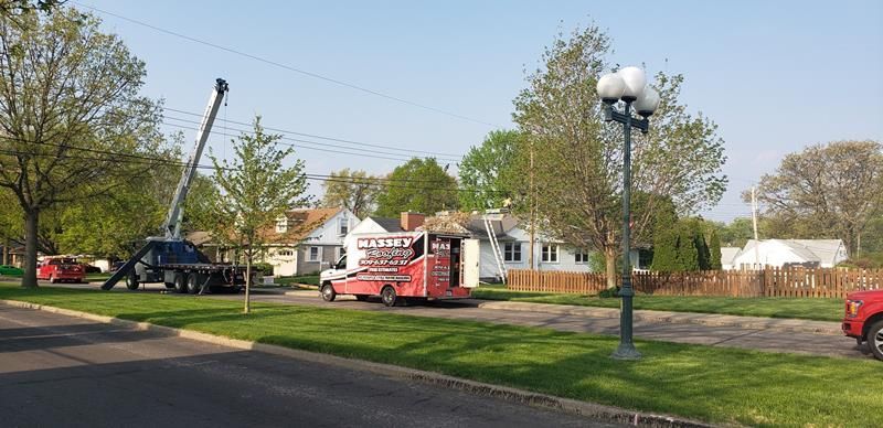 A red truck is parked on the side of the road next to a street light.