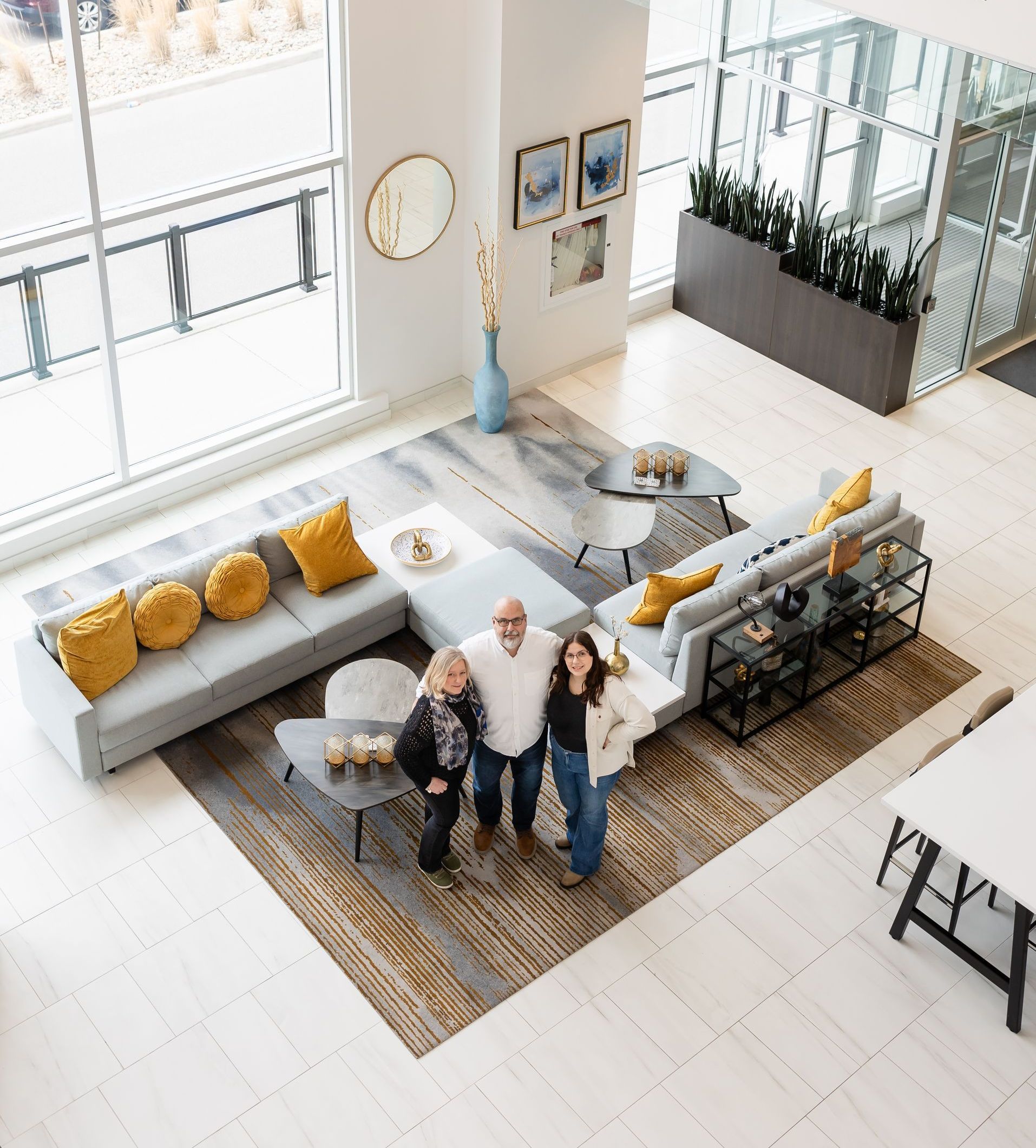 A group of people are posing for a picture in a living room.