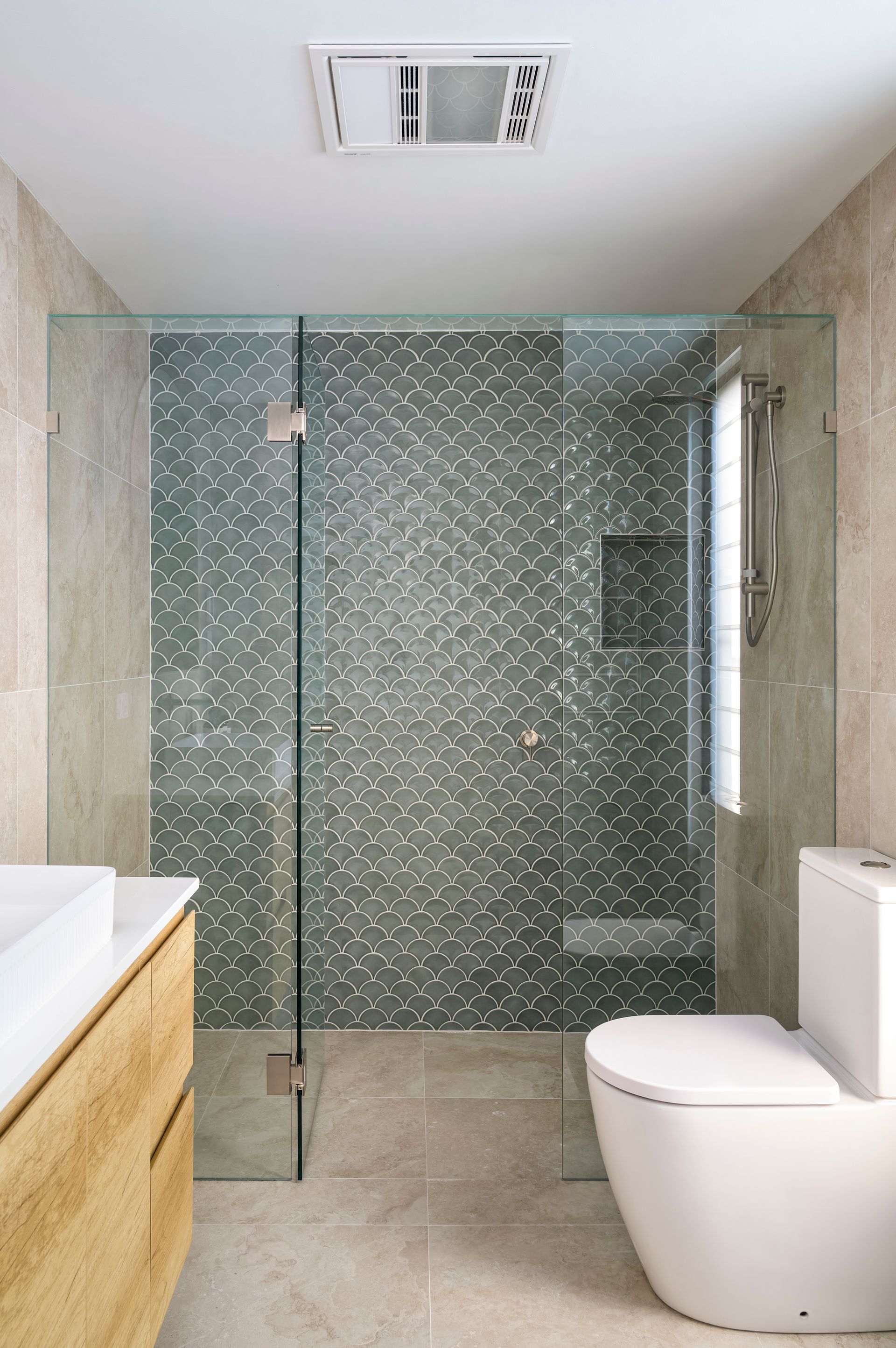 Accent Wall Of Green Fish Scale Tiles In Shower In Bathroom With A Toilet And Vanity Unit — Star Glass Design Pty Ltd in Mayfield, NSW
