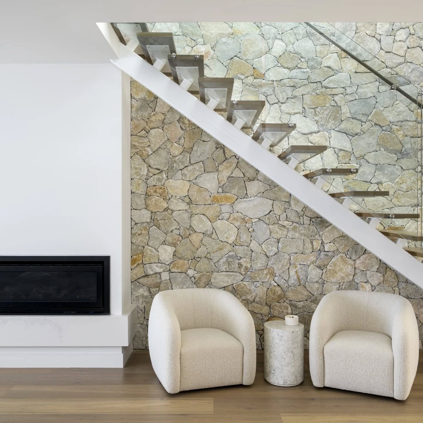 White Mono-Beam Staircase Above Two Boucle Lounge Chairs And Small Table Next To A TV — Star Glass Design Pty Ltd in Mayfield, NSW