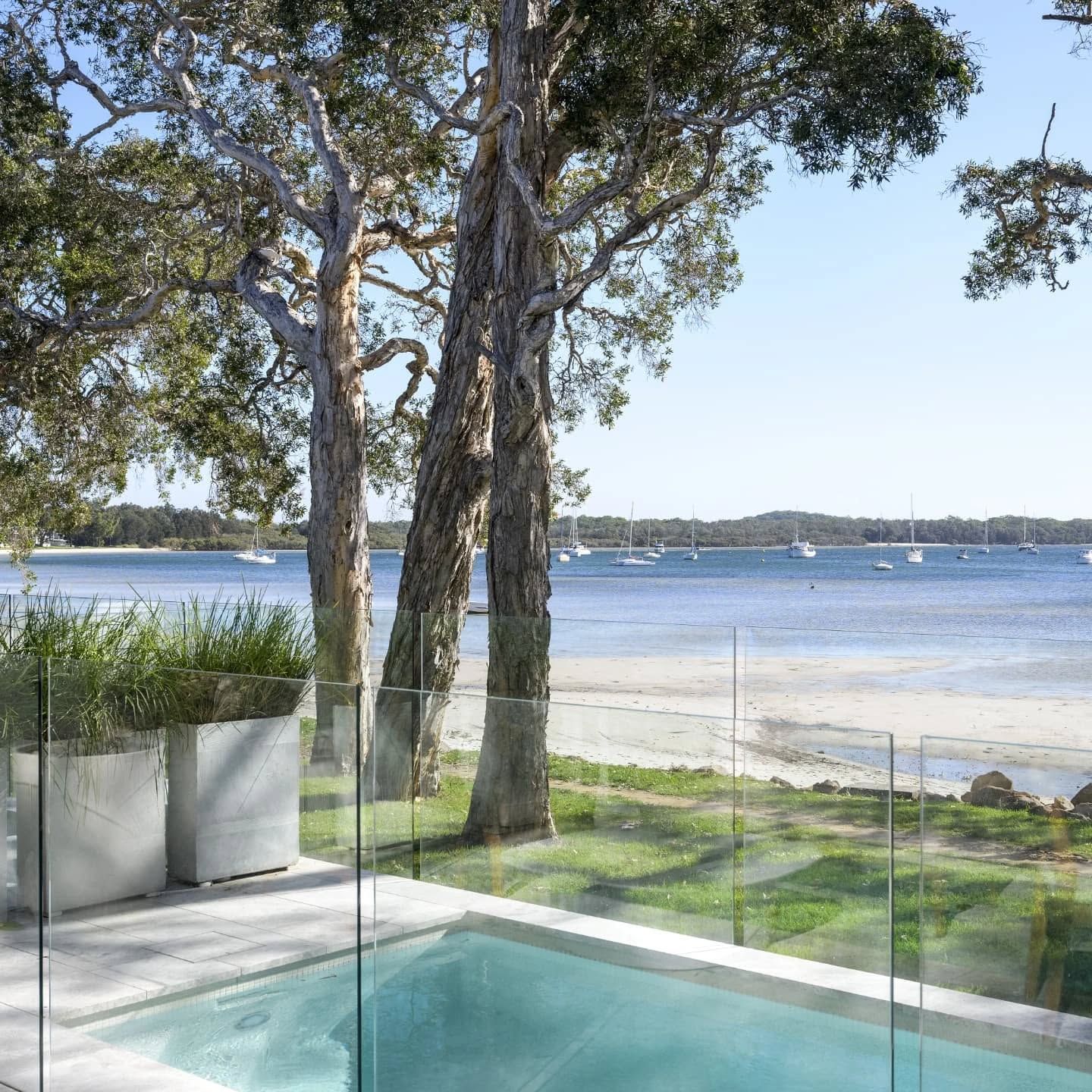 A Glass Pool Fence Surrounds A Swimming Pool By The Beachside — Star Glass Design Pty Ltd in Mayfield, NSW