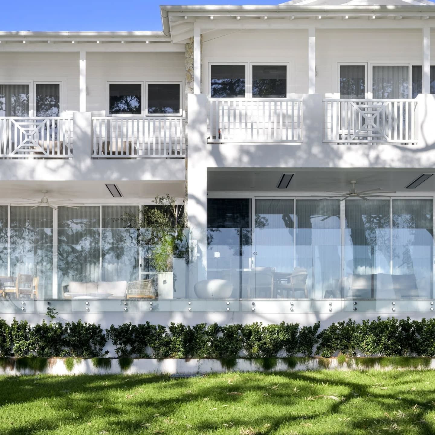 A Glass Fence Is Surrounding A Patio With A House In The Background — Star Glass Design Pty Ltd in Mayfield, NSW