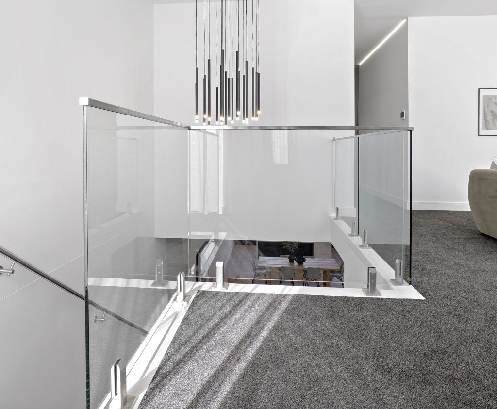 A Modern Staircase with A Glass Railing in A Living Room — Star Glass Design Pty Ltd in Mayfield, NSW