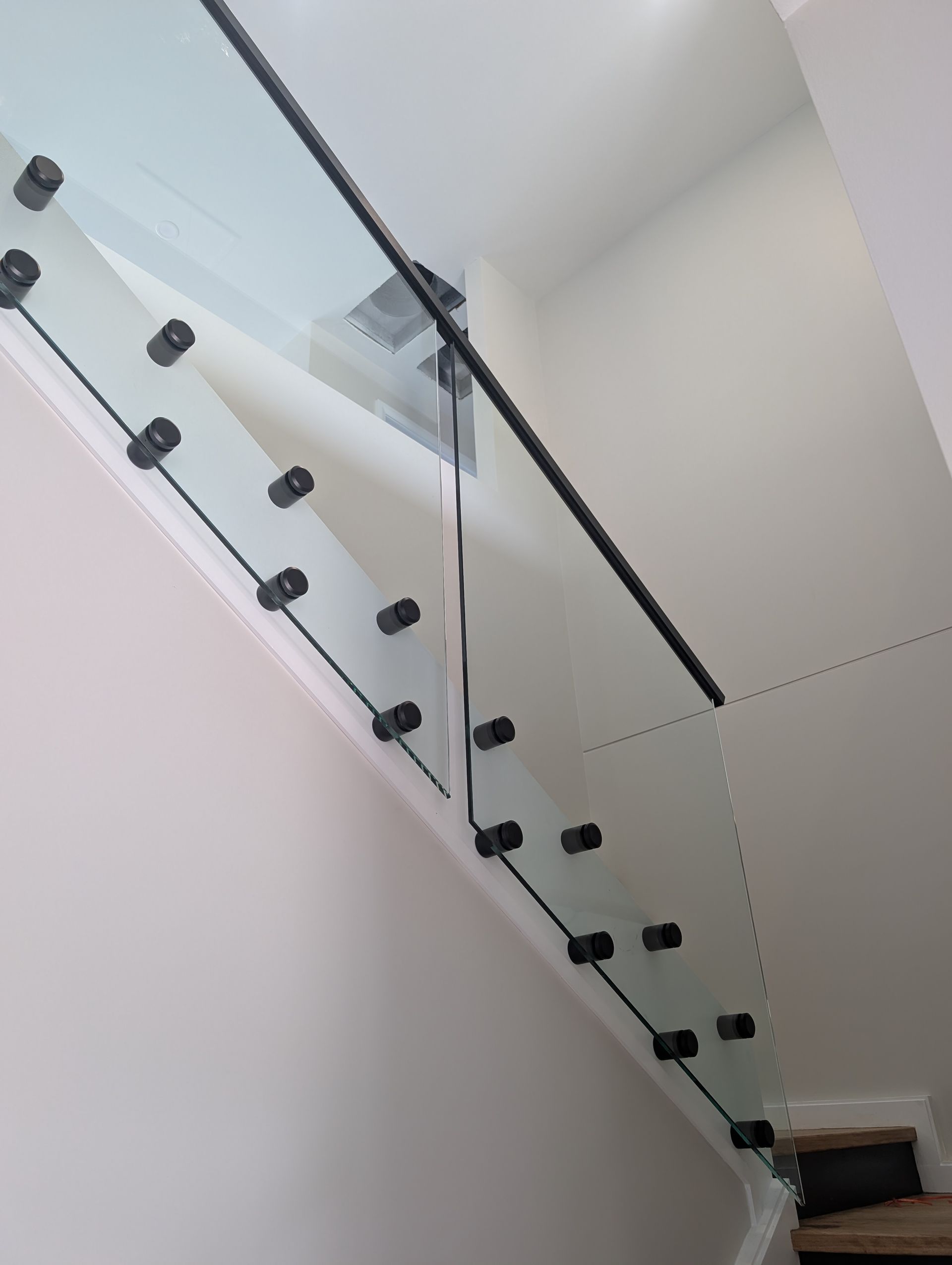Close-Up Of Glass Fence And Metal Railing Attached To Staircase — Star Glass Design Pty Ltd in Mayfield, NSW