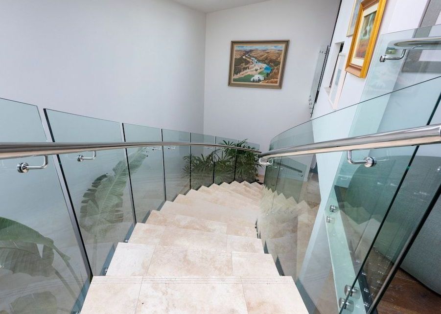 A Staircase With A Glass Railing And A Picture On The Wall — Star Glass Design Pty Ltd in Mayfield, NSW