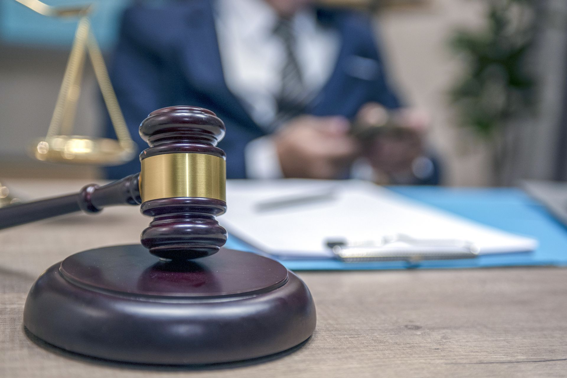 A judge's gavel and lawyer with documents symbolizing estate planning and legal consultation.