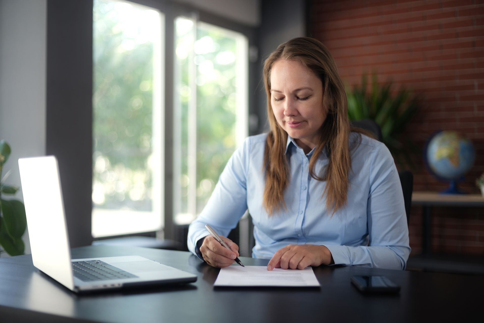 Estate planning lawyer signing an official document in her office.