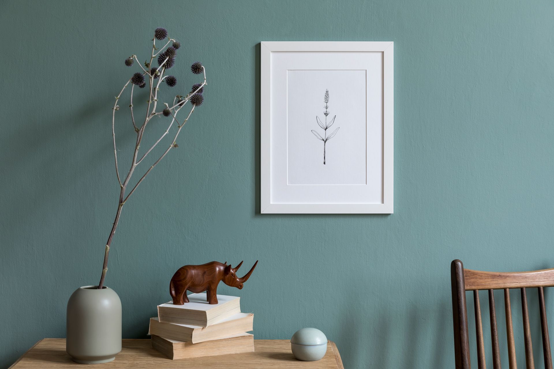 A Wooden Rhino Figurine Is Sitting on Top of a Stack of Books on a Table — Lakeland, FL — Thomason Furniture & Mattress