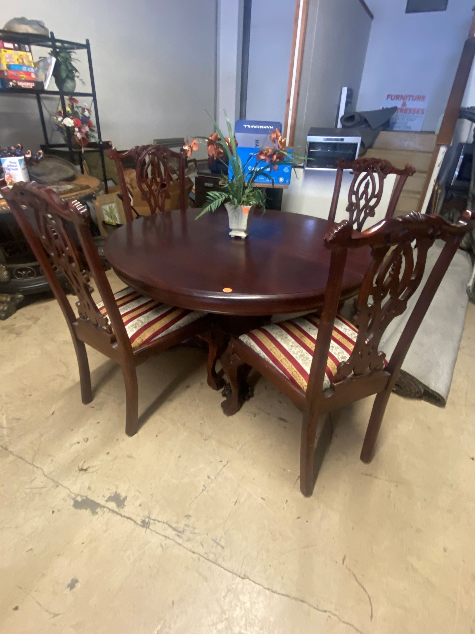 A Dining Room With a Long Table and Chairs and a Kitchen in the Background — Lakeland, FL — Thomason Furniture & Mattress