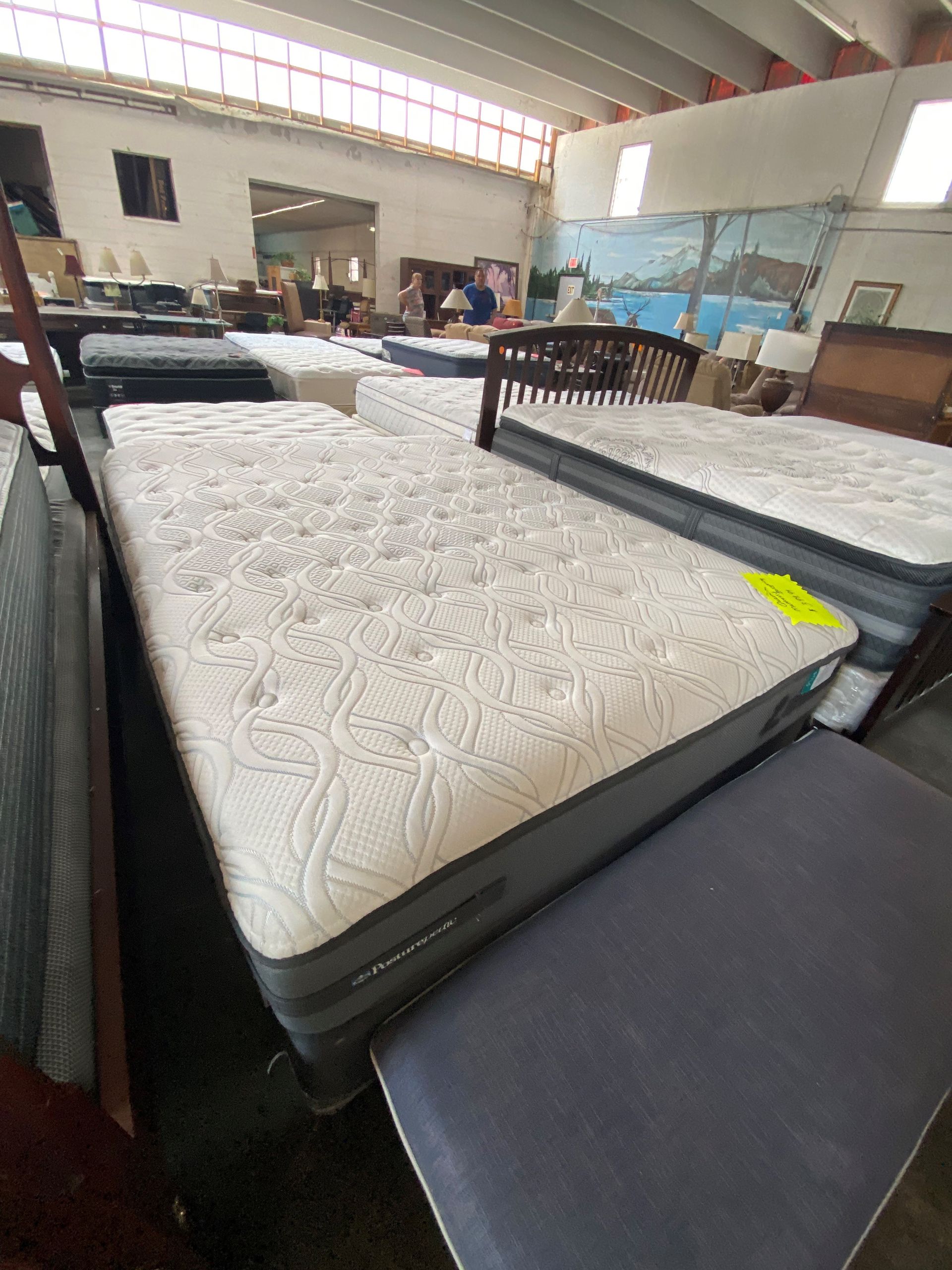 A Bunch of Mattresses Are Sitting on Top of Each Other in a Room — Lakeland, FL — Thomason Furniture & Mattress